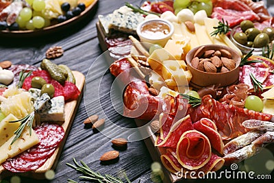 Tasty assorted appetizers served on black wooden table Stock Photo