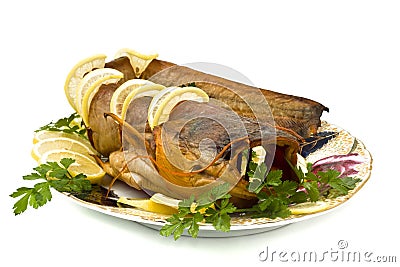 Tasty bloated sheatfish with lemon and parsley Stock Photo