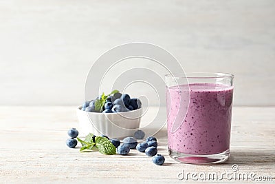 Tasty blueberry smoothie in glass, bowl Stock Photo