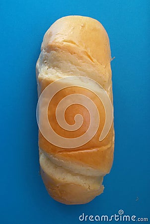 Delicious French roll bread. Soft and sweet bun over blue background. Stock Photo