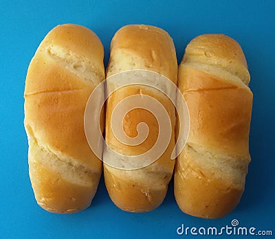 Delicious French roll breads. Soft and sweet buns over blue background. Stock Photo
