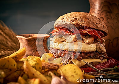 Tasty burger with beef, bacon, fried egg and mushrooms Stock Photo