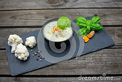 cauliflower soup with fresh turmeric and colored pepper Stock Photo