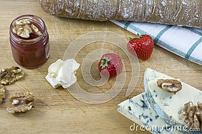 Tasty cheese roquefort and brie, bread, jam, nuts Stock Photo