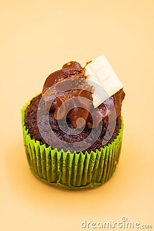 Tasty chocolate cupcake on orange pastel color background. Stock Photo