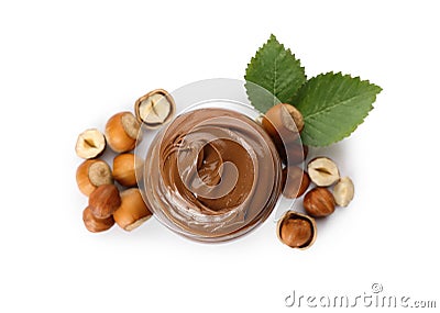 Tasty chocolate hazelnut spread and nuts on white background, top view Stock Photo