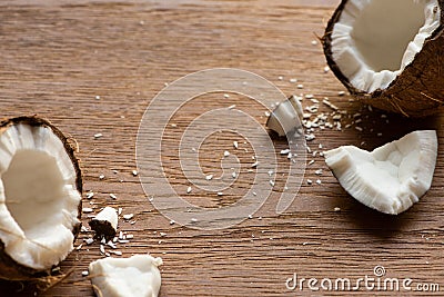 Tasty coconut halves near flakes on Stock Photo