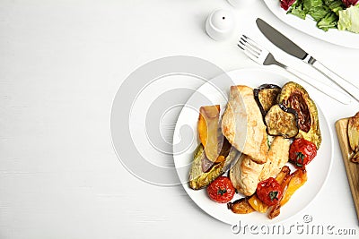 Tasty cooked chicken fillet and vegetables served on white wooden table, flat lay with space for text. Healthy meals from air Stock Photo