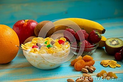 Tasty cornflakes with milk and fruits in glass bowl Stock Photo