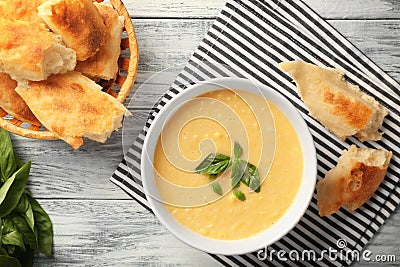 Tasty cornmeal mush with breads and basil leaves on table Stock Photo