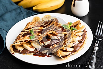 Tasty crepe with hazelnut chocolate spread and banana Stock Photo