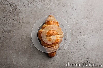 Tasty croissant on grey , top view. French pastry Stock Photo