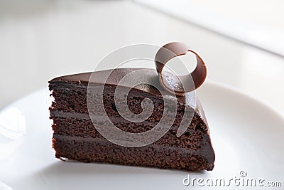 tasty dark chocolate cake on white plate. sliced delicious cocoa Stock Photo