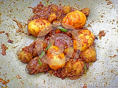 Tasty delicious Spicy Indian homemade roasted egg curry with potatoes and green chili masala Stock Photo