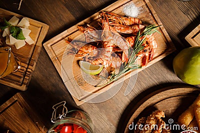 Tasty dish of large shrimps on a wooden table Stock Photo