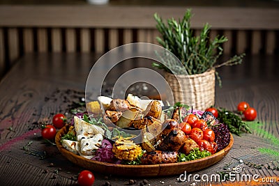 Tasty dish with meat and vegetables, baked pork, cowboy grill, grilled potatoes with sauce. Assorted tasty grilled meat with Stock Photo