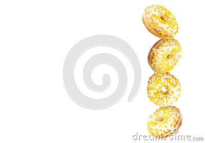 Tasty donuts with sprinkles falling on white background Stock Photo
