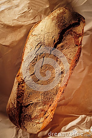 Tasty french bread in paper from bakery Stock Photo