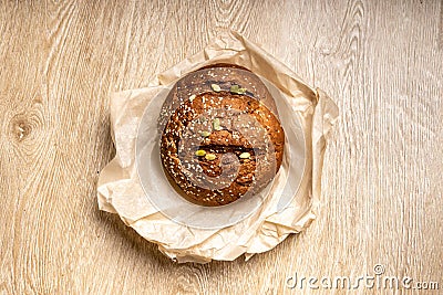 Tasty fresh baked loaf of dark bread with sesame seeds on light background Stock Photo