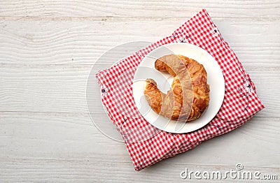 tasty Fresh crispy croissants arranged in white plate on cloth . Flat lay composition food photography. Stock Photo