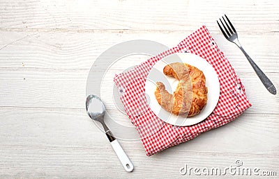 tasty Fresh crispy croissants arranged in white plate on cloth . Flat lay composition food photography. Stock Photo