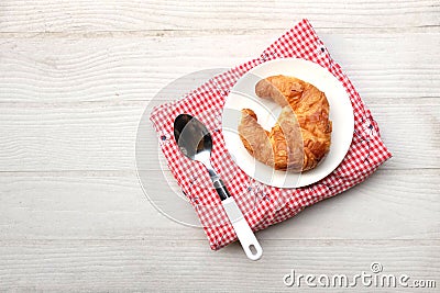 tasty Fresh crispy croissants arranged in white plate on cloth . Flat lay composition food photography. Stock Photo