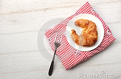 tasty Fresh crispy croissants arranged in white plate on cloth . Flat lay composition food photography. Stock Photo