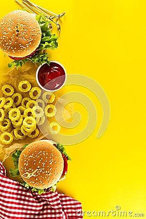 Tasty fresh unhealthy hamburgers with ketchup and vegetables and Stock Photo