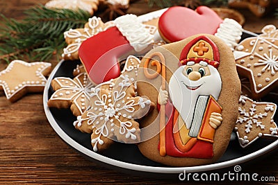 Tasty gingerbread cookies on wooden table, closeup. St. Nicholas Day celebration Stock Photo