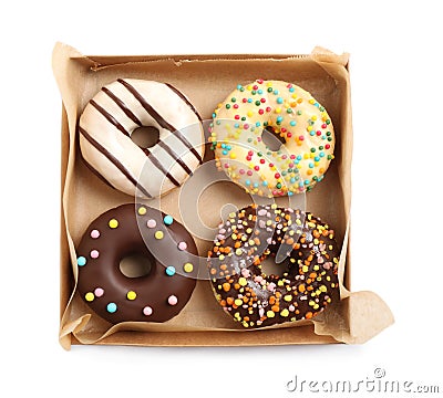 Tasty glazed donuts in cardboard box isolated on white, top view Stock Photo