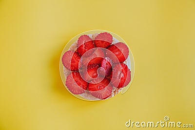 Tasty and healthy snack, crispbread with strawberry slices on a yellow background Stock Photo