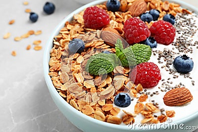 Tasty homemade granola with yogurt and berries on grey table, closeup. Healthy breakfast Stock Photo