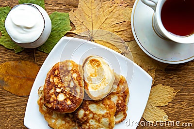 Tasty homemade pancakes and maple leafs on the table, top view. Warm golden autumn concept. Stock Photo