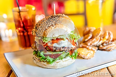 Tasty Juicy American Beef Burger Menu With Lettuce, Ketchup And Potato Chips In Fast-Food Restaurant Stock Photo
