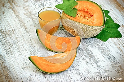 Tasty and juicy melon - cantaloupe and melon juice smoothie on rustic table Stock Photo