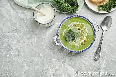 Tasty kale soup served on light grey marble table, flat lay. Space for text Stock Photo