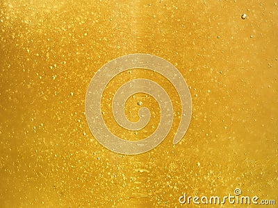 Tasty liquid background of fresh Golden honey with tiny bubbles glistening in the sun Stock Photo