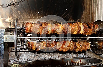 Tasty meat cooked in the fireplace with the spit 2 Stock Photo