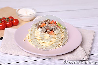 Tasty minced meat with spaghetti and vegetables on white wooden table Stock Photo