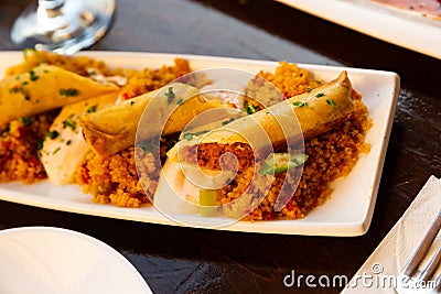 Tasty Moroccan lamb spring roll with harissa and couscous Stock Photo