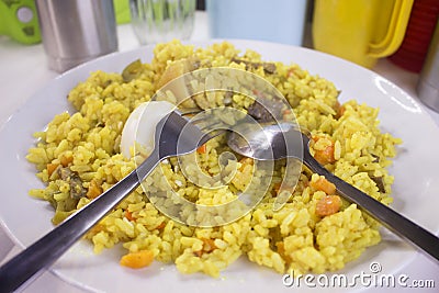 Tasty Nigerian Fried Rice with a boiled egg and chopped meat Stock Photo