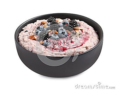 Tasty oatmeal porridge with different toppings in bowl on white background Stock Photo