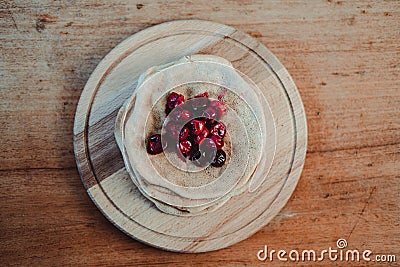 Tasty pancakes with cherries on a cutting board Stock Photo