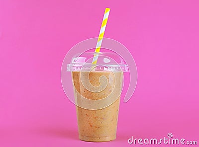 Tasty peach milkshake in plastic cup Stock Photo