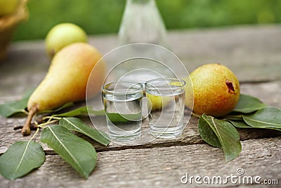 Tasty pear brandy in shot glass Stock Photo