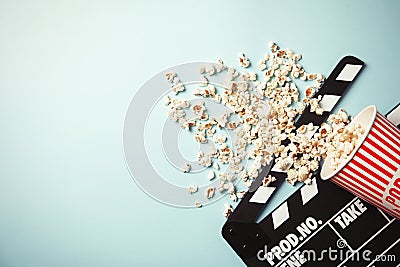 Tasty popcorn and clapperboard on color background, top view with space for text Stock Photo