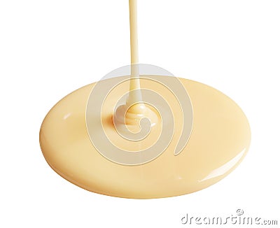 Tasty pouring condensed milk on white background Stock Photo