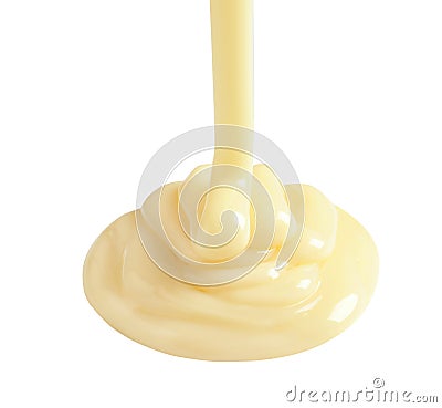 Tasty pouring condensed milk on white background. Stock Photo