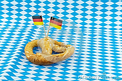 Tasty pretzel symbol brewing holiday oktoberfest on white and blue rhombus pattern bavaria Stock Photo