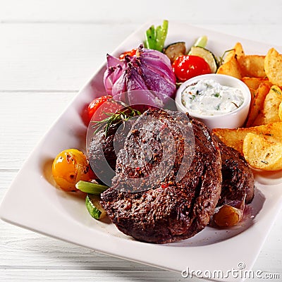 Tasty Roasted Beef Steak with Potatoes and Sauce Stock Photo